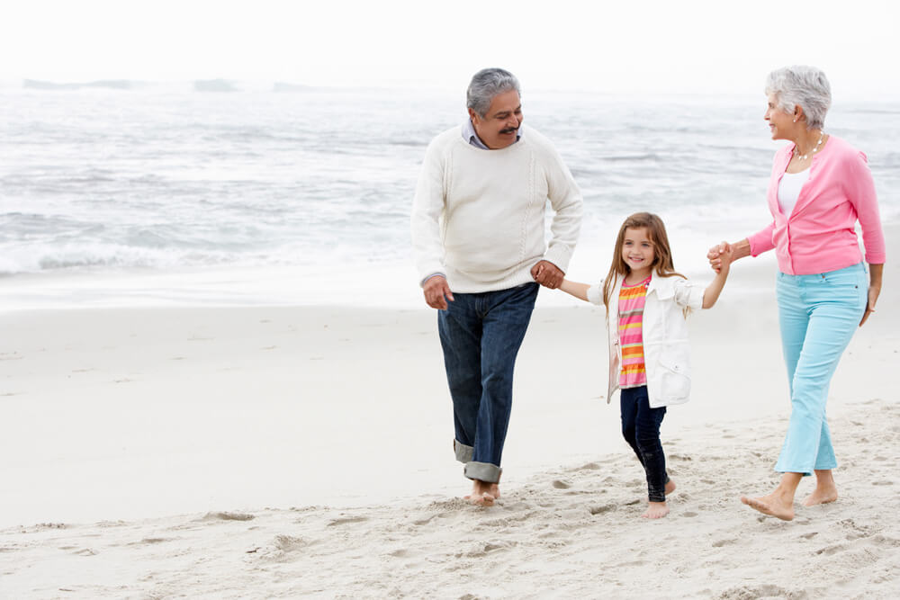 Grandparents and grandchild on beach